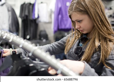 Pretty Teenager Shopping For Clothes In A Boutique/fashion Shop/store (shallow DOF; Color Toned Image)