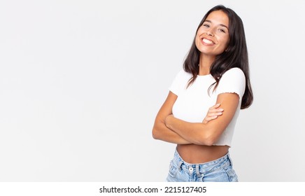 pretty thin hispanic woman laughing happily with arms crossed - Shutterstock ID 2215127405