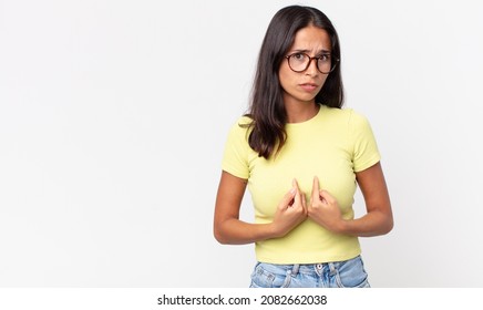 Pretty Thin Hispanic Woman Pointing To Self With A Confused And Quizzical Look