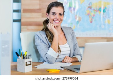 Pretty Travel Agent Smiling At Camera In The Office