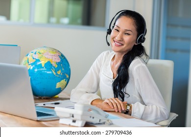 Pretty Travel Agent Smiling At Camera In The Office