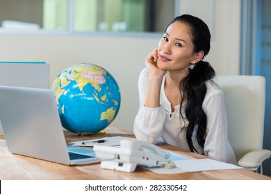 Pretty Travel Agent Smiling At Camera In The Office