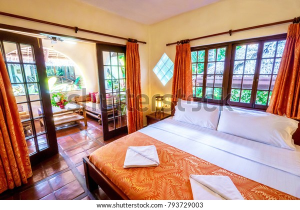Pretty Tropical Resort Bedroom Yellow Walls Stock Photo