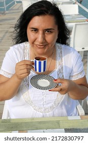 Pretty Turkish Woman Drinking  Turkish Coffee At Cafe