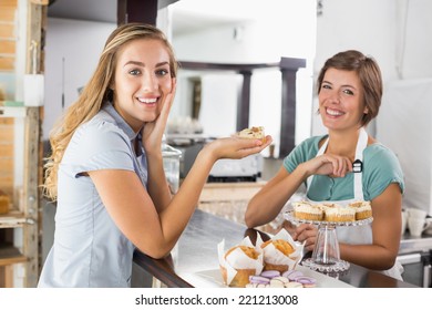 Pretty Waitress Serving Cupcake To Customer At The Coffee Shop