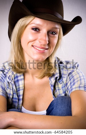 pretty western woman in cowboy shirt and hat isolated on white background