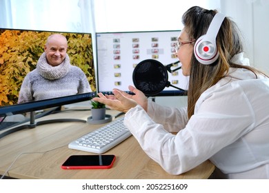 pretty woman 40-45 years old sits in front of computer, emotionally speaks to man on internet, being separated from one’s family and friends during quarantine covid 19, social distancing