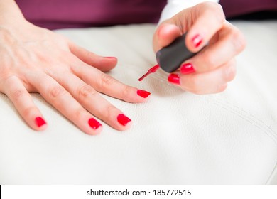 Pretty Woman In Bed Applying Nail Polish