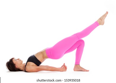Pretty woman in bridge yoga pose. Isolated on white studio background.
