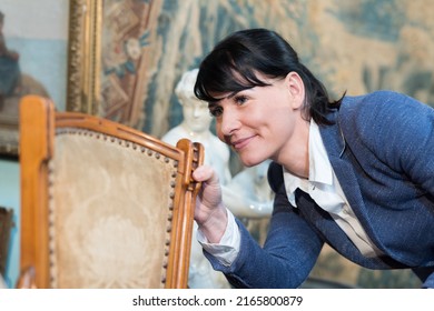 Pretty Woman Choosing The Right Furniture In Antique Shop