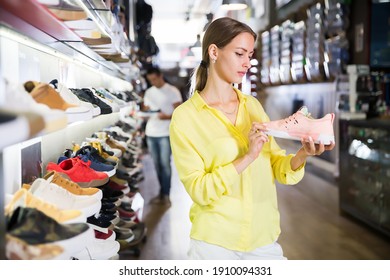 Pretty Woman Choosing Sneakers In Streetwear Store