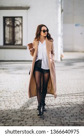 Pretty Woman In Coat Drinking Coffee Outside In The Street