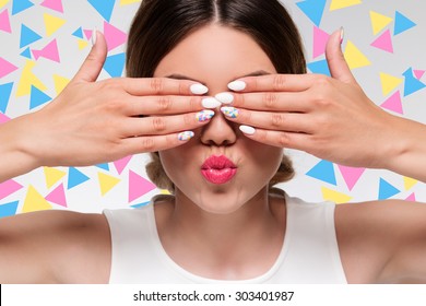 Pretty Woman With Colorful Gel Nails Hiding Her Eyes With Fingers 