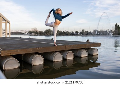 Pretty Woman Curly Hair Yoga Teacher Practicing In The Park At Sunset