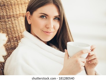 Pretty woman drinking her morning tea at home. - Powered by Shutterstock