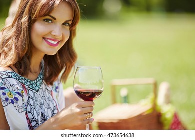 Pretty Woman Drinking Wine On The Picnic