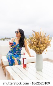 Pretty Woman Drinking Wine From A Terrace