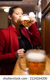 Pretty Woman Drinks Pint Of Beer In. Traditional Pub. 