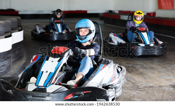 Pretty woman driving sport car for karting in a\
circuit lap in sport\
club