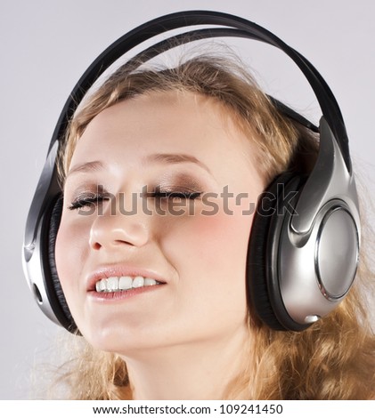 Similar – Blonde woman listening to music with her headphones