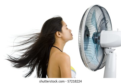 Pretty Woman Enjoying Fan Blowing From Front Right Side, Isolated On White Background