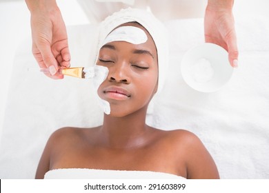 Pretty woman getting a facial treatment at the health spa