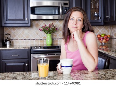 Pretty woman having breakfast in a kitchen - Powered by Shutterstock