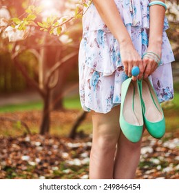 Pretty Woman With Her Shoes In Summer Park