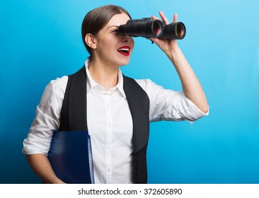 Pretty woman holding binoculars. Searching for new opportunities business concept