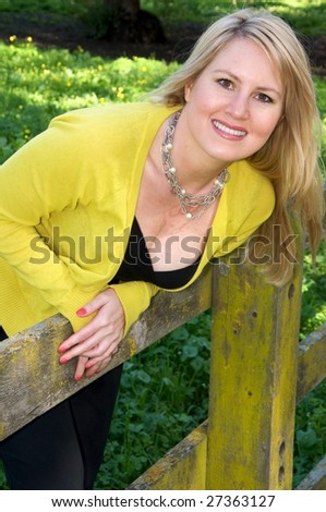 Pretty woman leaning over a fence