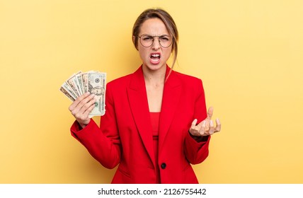 Pretty Woman Looking Angry, Annoyed And Frustrated. Business And Dollar Banknotes Concept