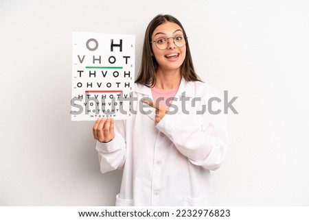 pretty woman looking excited and surprised pointing to the side. optical vision test concept
