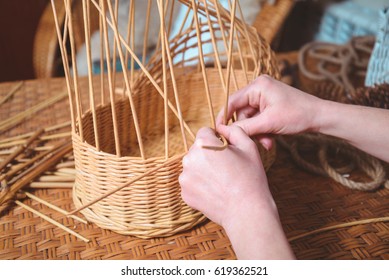 pretty woman making basktes indoor, handmade business - Shutterstock ID 619362521