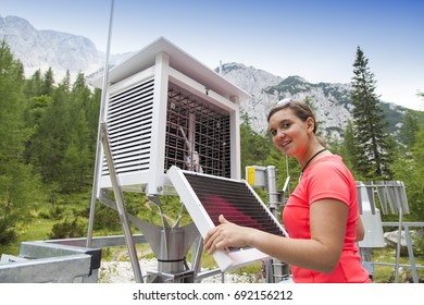 Pretty Woman Meteorologist Reading Meteodata Instruments In Modern Meteorologic Observation Station, High In Mountains