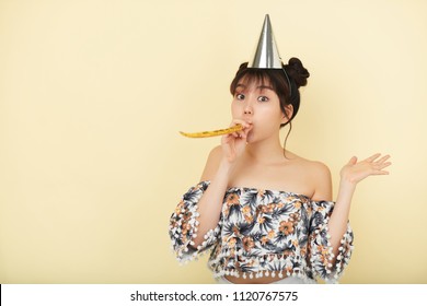 Pretty Woman In Party Hat Blowing In Whistle