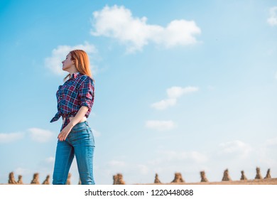 Pretty woman plus size with big hips in american country style plaid shirt and jeans. Travel concept, adventure and trip time - Shutterstock ID 1220448088