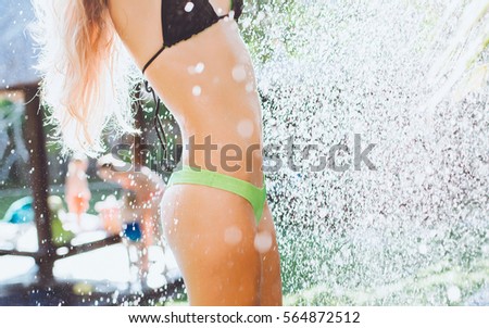 Pretty woman posing in the wash, body fitness
