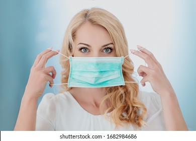 Pretty Woman Putting On A Medical Face Mask Respirator