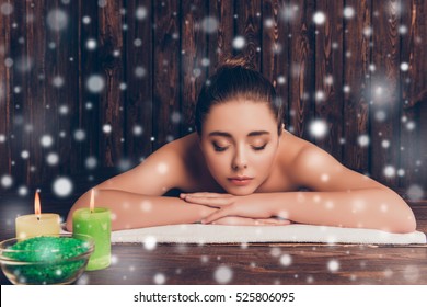 Pretty woman relaxing on aromatherapy on snowy winter background.