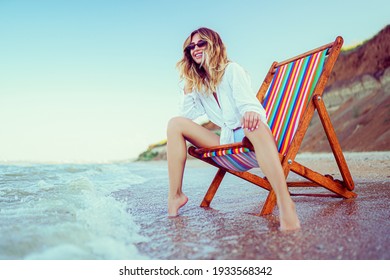 Pretty woman relaxing on a lounger beach. summer vacation concept. Copyspace