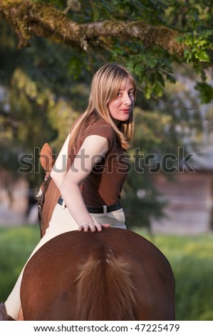 Pretty woman riding her horse bareback