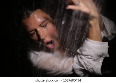 Pretty Woman In Shock Closes Her Hands From A Cold Shower.