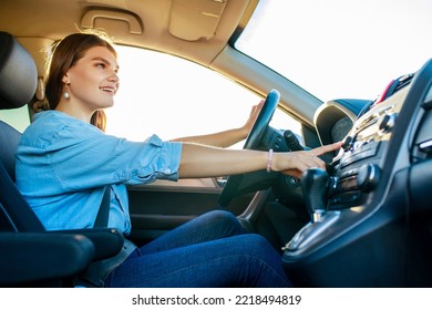 pretty woman singing while driving a car on road trip on summer day - Shutterstock ID 2218494819