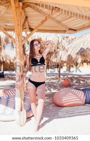 Similar – Brunette surfer woman with top and bikini holding surfboard