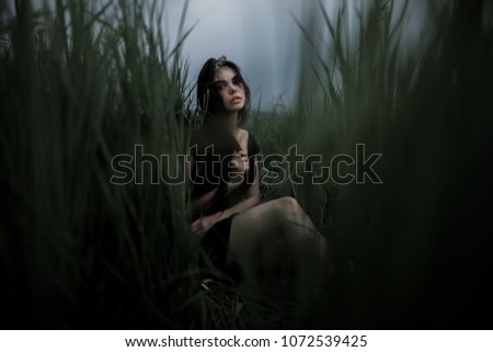 Similar – beautiful young woman siiting outdoors in forest, dreaming with closed eyes in serene pose