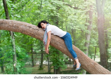 Pretty Woman Sleeping In A Tree After Being Over Worked And Having Trouble Sleeping 

