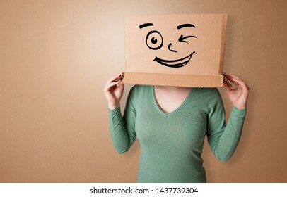 Pretty Woman Standing And Gesturing With A Carton Box On Her Head