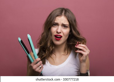 Pretty Woman Styling Her Hair With A Curling Iron