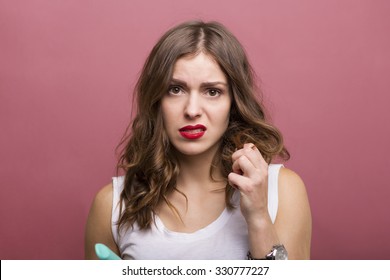 Pretty Woman Styling Her Hair With A Curling Iron