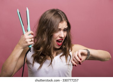 Pretty Woman Styling Her Hair With A Curling Iron